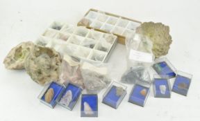 Two mineral geodes and a collection of mineral samples in named boxes and several in bags