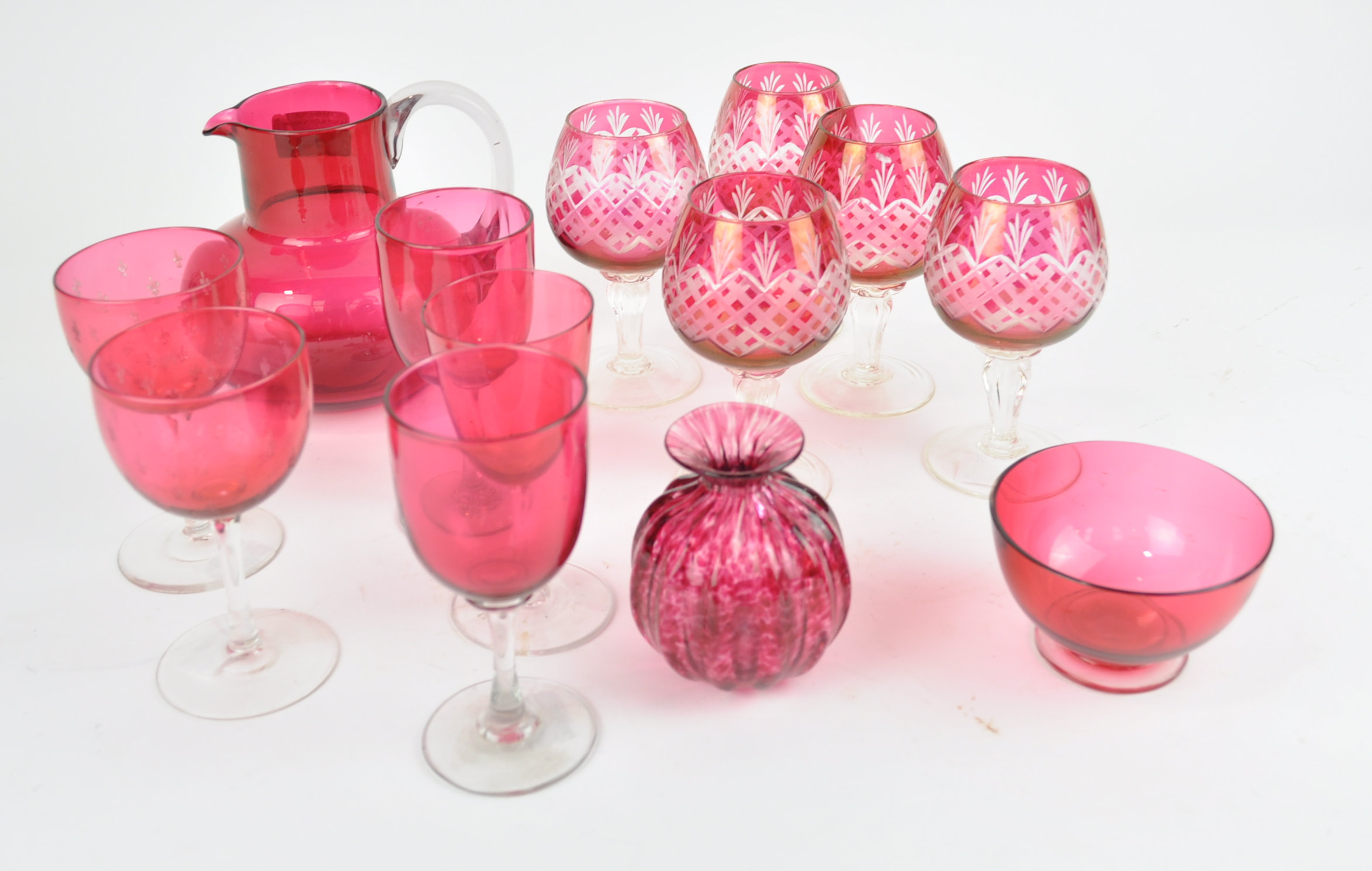 A set of five cranberry flash and cut glasses and other glass