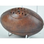 A miniature leather vintage style rugby ball,