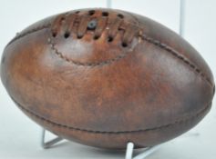 A miniature leather vintage style rugby ball,