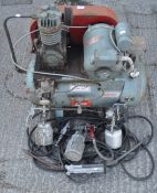 A Motivair compressor with hoses and other items