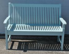 A green painted Country Gates garden bench