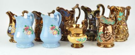 Seven copper lustre jugs and two others