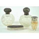 Two silver topped cut glass scent bottles and two boxes