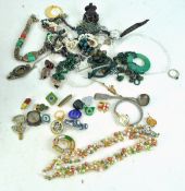 A collection of assorted costume jewellery to include, silver spoon, enamel badges,