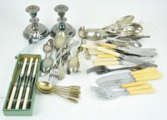 A collection of assorted silver plate and stainless flatware along with a pair of silver plated