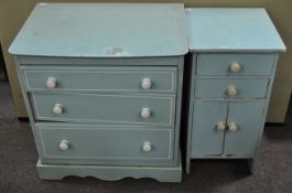 A child's bedroom set consisting of a small chest of drawers along with a cupboard both painted in