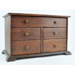 A small mahogany chest of drawers, of one long and four short drawers,