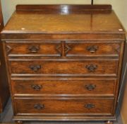 An oak chest of two short and three long drawers