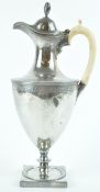 A silver neo classical hot water jug with shaped domed cover,