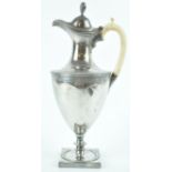 A silver neo classical hot water jug with shaped domed cover,