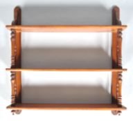 A 19th century mahogany hanging three tier wall shelf with tapered uprights,