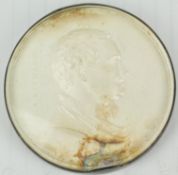 A cased and glazed silver medal,