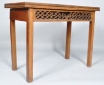 A George III mahogany tea table, of plain rectangular form, with fold over top to a rear gateleg,