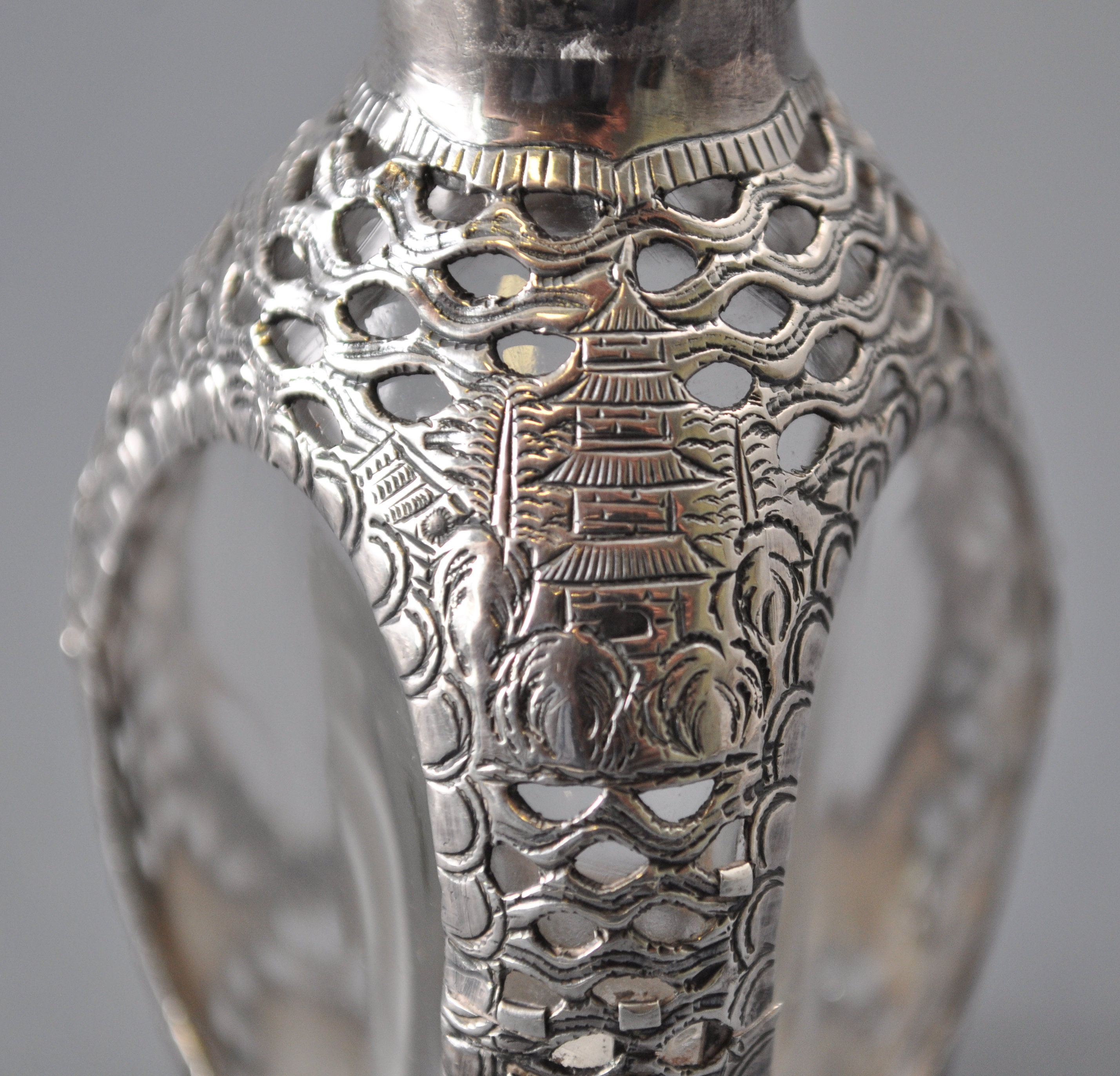 An Asian glass bitters bottle of dimpled triangular form, overlaid in a white metal sleeve, - Image 3 of 5