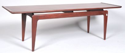 A 1970's retro vintage teak wood long john coffee table having a long floating table top raised on