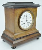 A late 19th century mantle clock, the enamel dial in walnut and ebonised case,