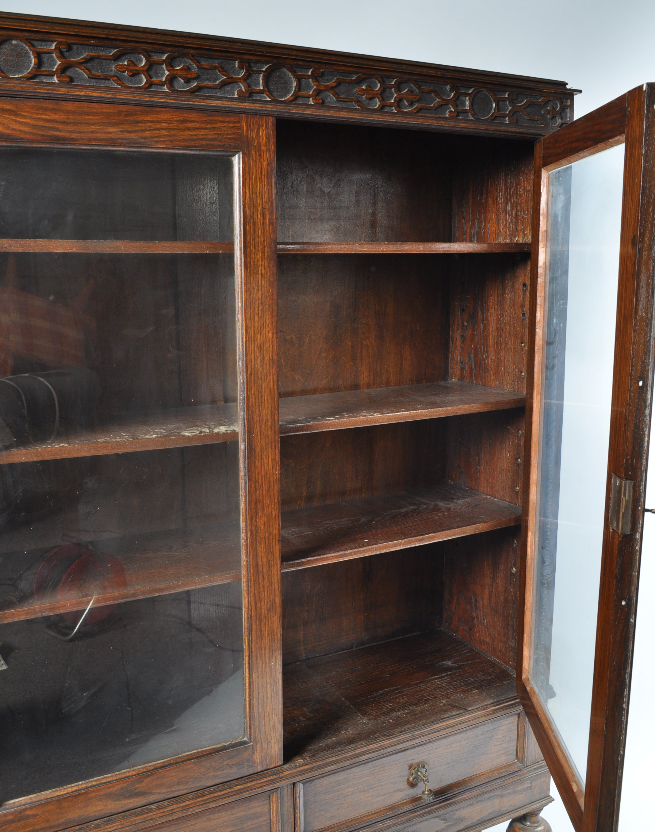 An oak display cabinet with two glazed doors above two frieze drawers on baluster turned legs, - Image 4 of 4