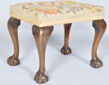 A George III style stool with tapestry seat and carved cabriole legs with ball and claw feet,