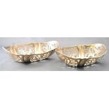 A pair of small silver cake baskets, of shaped oval form,