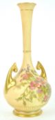 A Royal Worcester blush ivory baluster two handled vase, decorated with a floral spray,