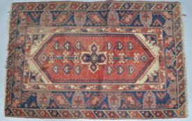 A Middle Eastern rug with central red panel,