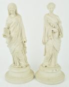 A pair of Parian figures of maidens in draped dresses, one holding a book,