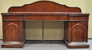 A late 19th century Victorian antique mahogany sideboard having a shaped back