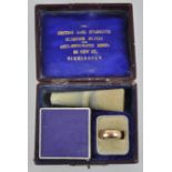 A boxed 9ct anti-rheumatic ring. 4.19 grams total weight.