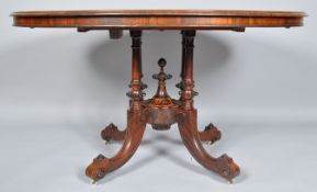 A Victorian rosewood and marquetry loo table, the oval tilt top on four tapering fluted supports,