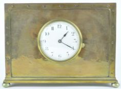 A mantle clock, the enamelled dial in rectangular copper and brass case on bun feet,