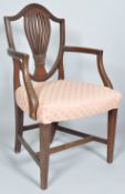 A 19th Century George III style mahogany open armchair / carver having a shield shaped back with