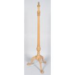 A beech wood tripod standard lamp, of column form,