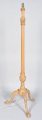 A beech wood tripod standard lamp, of column form,