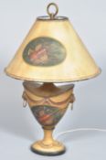 A 20th century Tole ware lamp having a urn shaped lamp base with lion masks and hoops to either