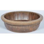 A large staved wooden mixing bowl with iron bindings,
