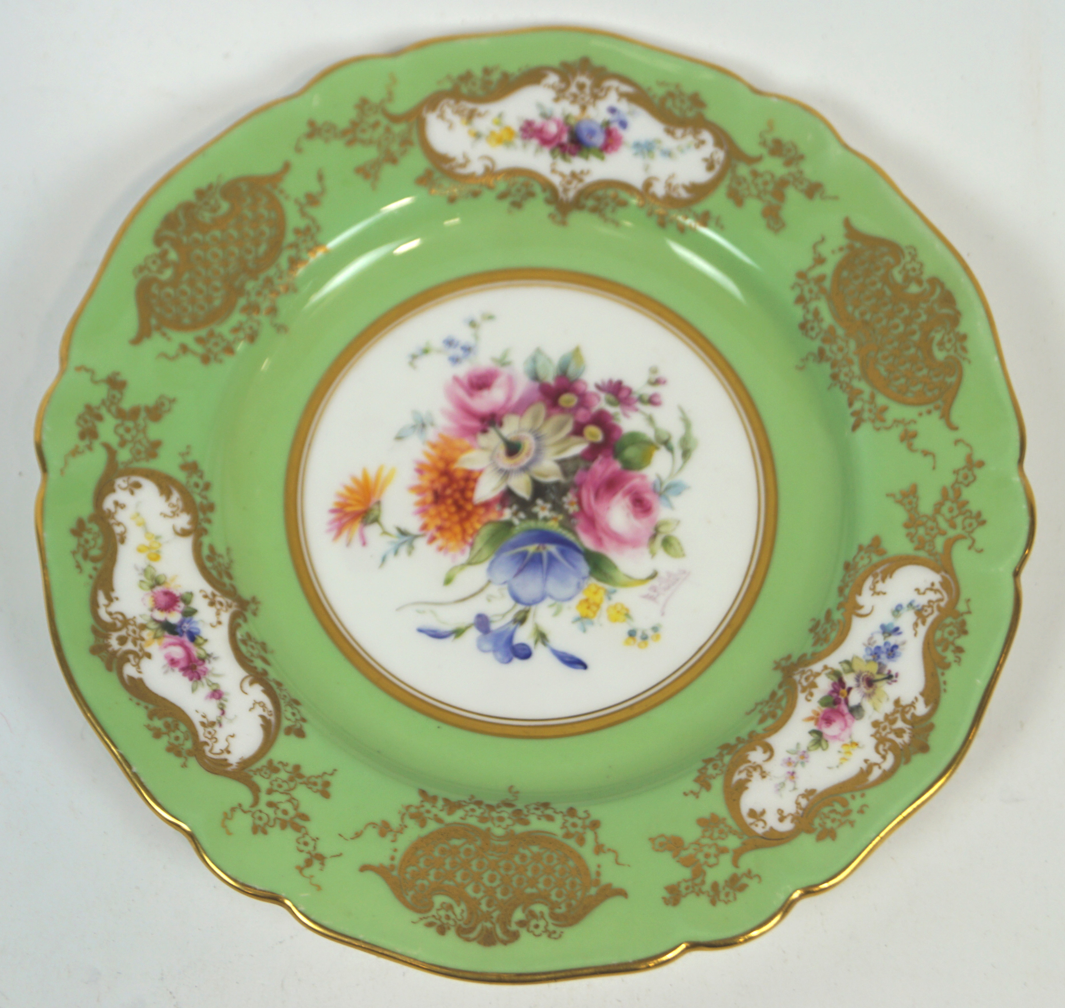 A Royal Worcester Sevres style cabinet plate with a central polychrome floral panel of roses,