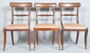 A set of three early 19th century Regency mahogany bar back dining chairs with ovoid top rail and