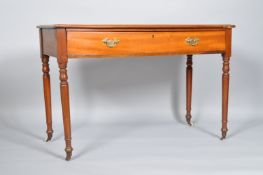 A mahogany desk, of plain rectangular form, with shaped edge, over a frieze drawer,