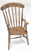 A farmhouse armchair with turned stick back and arm supports,