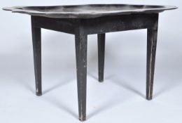 A 20th Century antique bespoke tray table comprising of an ebonised scalloped metal tray top raised