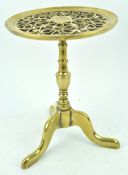 A19th century brass trivet, in the form of a tripod table with pierced top,