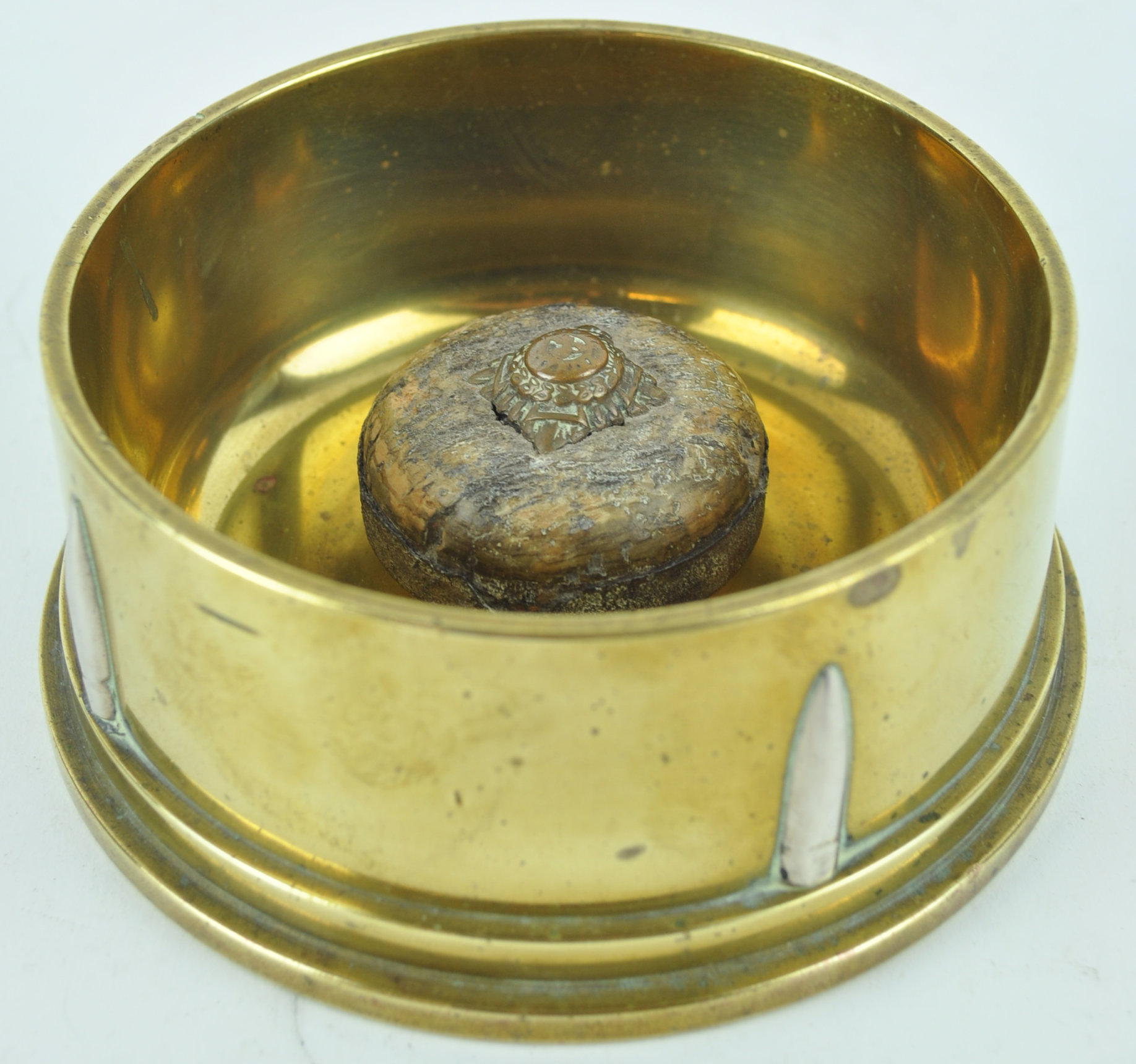 A 1942 trench art ashtray, constructed from the base of a shell case with bullet head decoration,