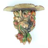 A carved wood and polychrome painted wall bracket, in the form of grapes and other fruit,