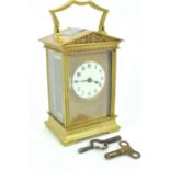 A late 19th/early 20th Century antique French brass carriage clock having an enamelled face