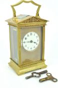 A late 19th/early 20th Century antique French brass carriage clock having an enamelled face