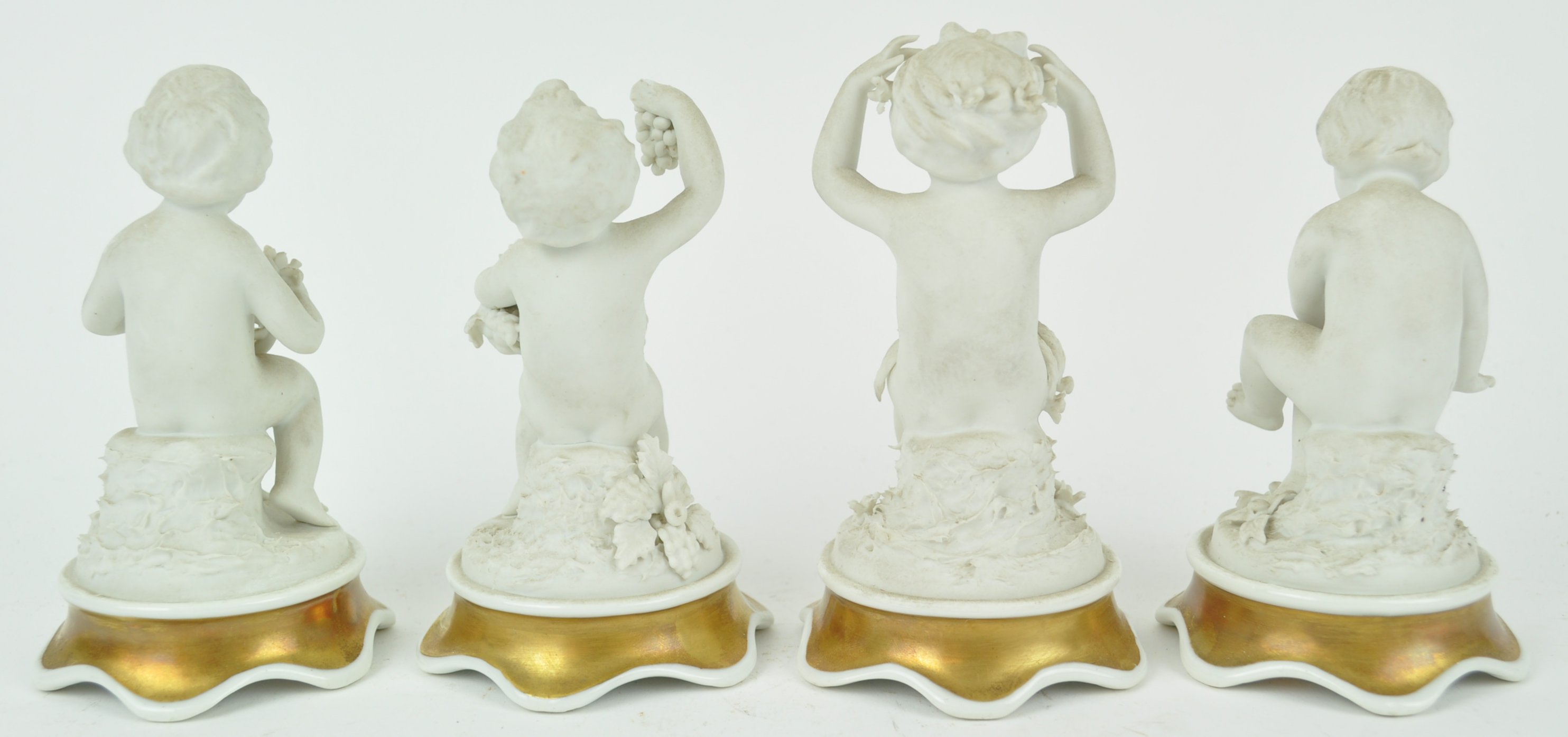 A set of four Continental bisque figures of putti depicting the Four Seasons, - Image 2 of 3