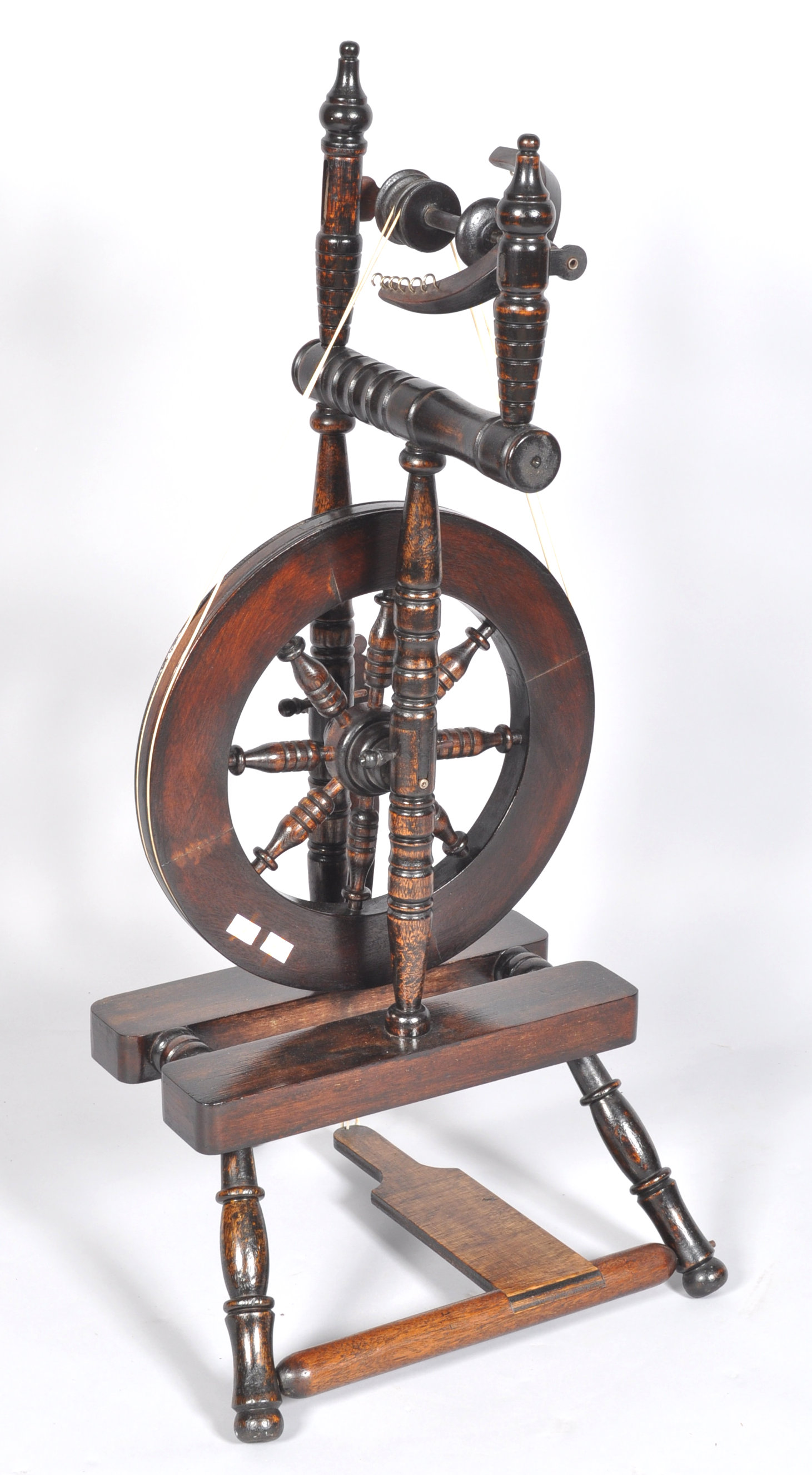 A contemporary castle style turned stained oak spinning wheel. Measures; 103cm. - Image 2 of 2