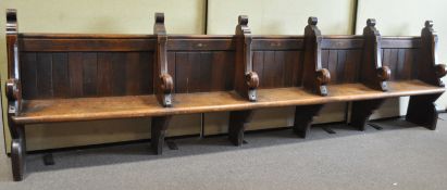 A Victorian oak choir stall for five choristers, the plank back with solid seat, 102cm high,