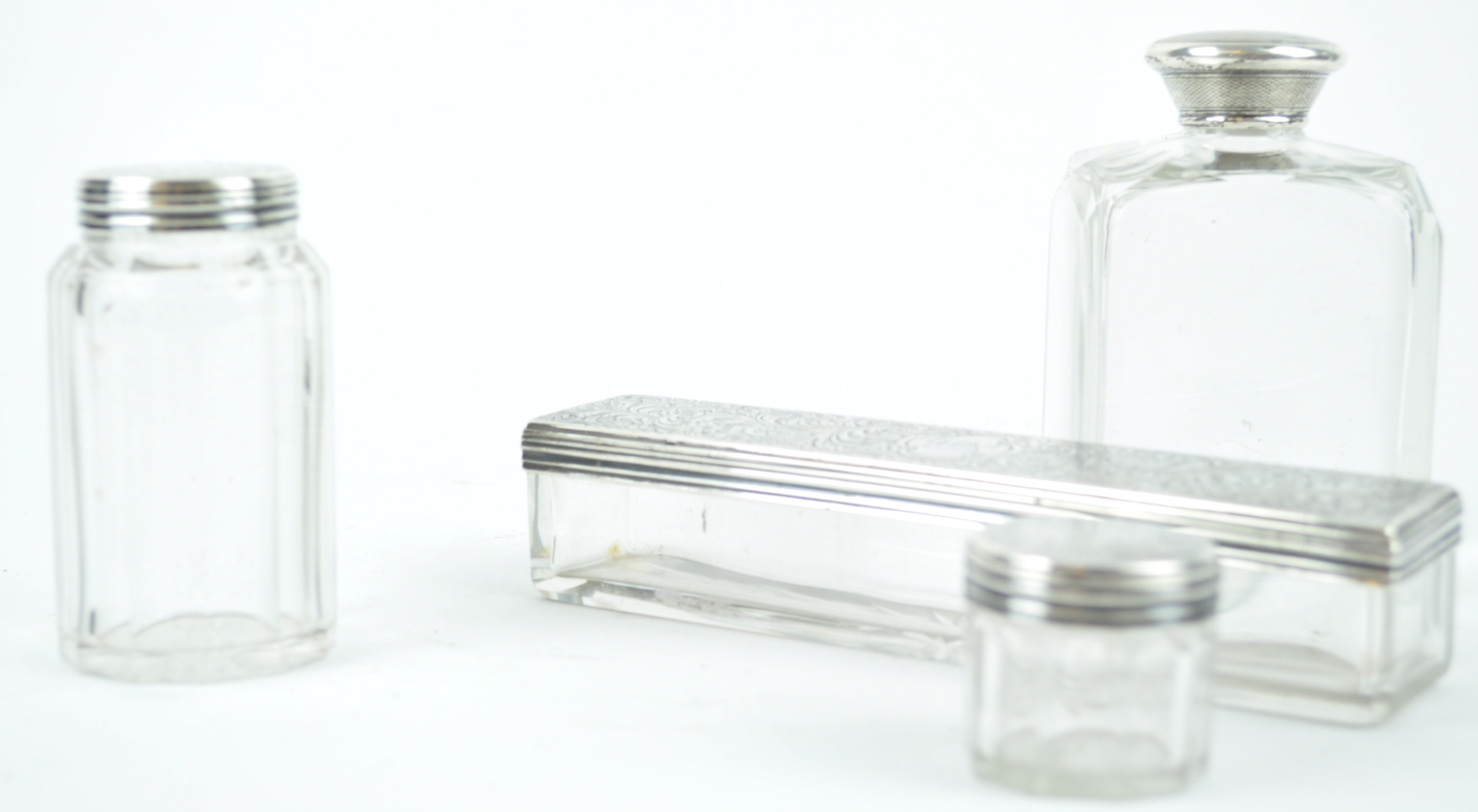 Three silver lidded cut glass dressing jars with silver lids, London 1853,